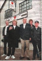 The band pose outside The Stumble Inn